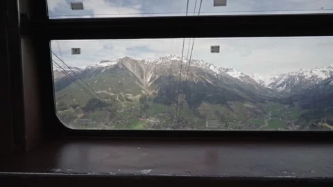 Alpine valley seen through a cable car window on a spring day 動画素材 310034039