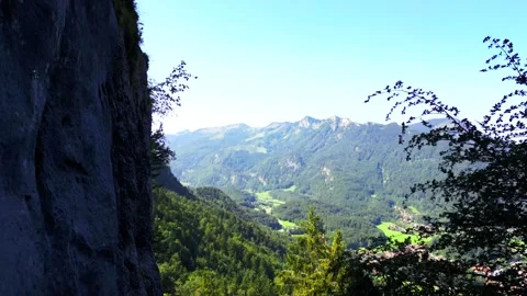 Alpine valley on a sunny summer day as seen from a drone on the forest edge Stock Footage 282965101
