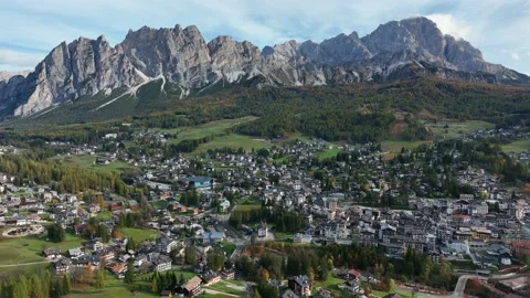 Alpine village under a mountain range in the center of a valley. Stock Footage 221187829