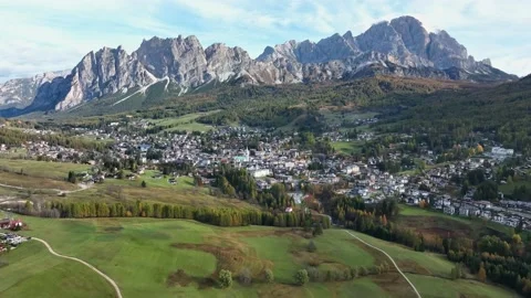 Alpine village under a mountain range in the center of a valley. Stock Footage 221187901