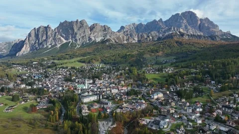 Alpine village under a mountain range in the center of a valley. Stock Footage 221187960