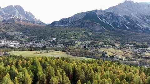 Alpine village under a mountain range in the center of a valley. Stock Footage 221188025