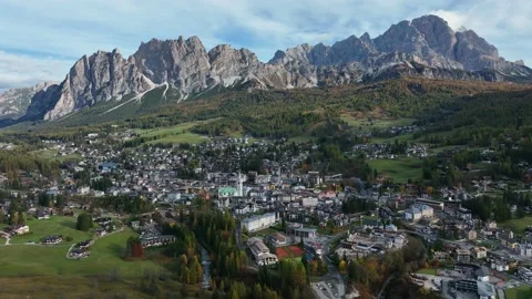 Alpine village under a mountain range in the center of a valley. Stock Footage 221188170