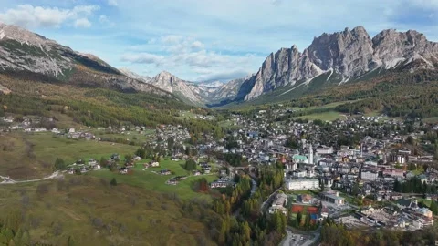 Alpine village under a mountain range in the center of a valley. Stock Footage 221188247