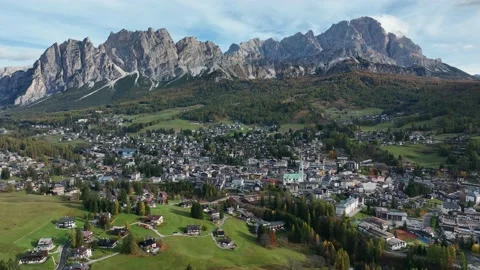 Alpine village under a mountain range in the center of a valley. Stock Footage 221188524