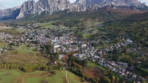 Alpine village under a mountain range in the center of a valley. Stock Footage 221188539