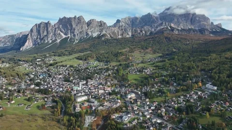 Alpine village under a mountain range in the center of a valley. Stock Footage 221188617