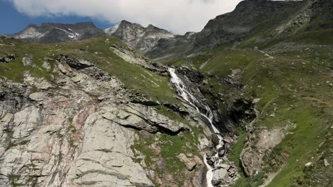 Alpine waterfall flows through rocks on Italian Alps Stockbeeldmateriaal 255201069