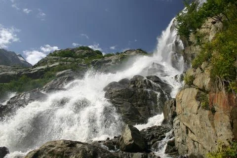 Alpine waterfall in mountain Stock Photos