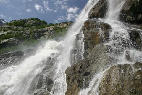 Alpine waterfall in mountain Stock Photos