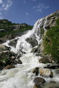 Alpine waterfall in mountain 写真素材