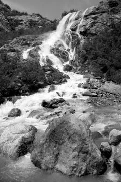 Alpine waterfall in mountain 写真素材