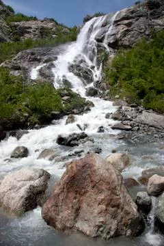 Alpine waterfall in mountain Stock Photos
