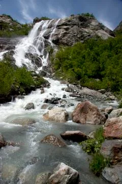 Alpine waterfall in mountain 写真素材