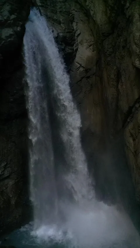 Alpine Waterfall in Narrow Gorge with Tall Cliff Walls – 4K Vertical Video stock 328706159