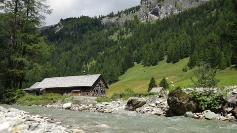 Alpine herdsmen's hut on mountain river,alm Stock Footage 90144147
