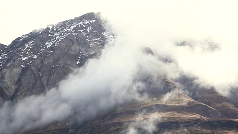Alps. Clouds on high-mountain snow-capped peaks. Alpine meadows Stock Footage 81233484