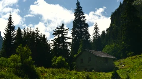 Alps montains clouds shadows chalet swiss Stock Footage 54720780