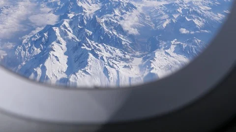 Alps mountains peak view through aircraft window Vídeos de archivo 106949791