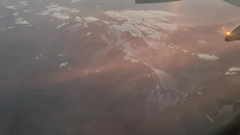 Alps Seen from Airplane Above Clouds at Sunset, Italy (15 Sept 2026) Stock-Footage 345587496