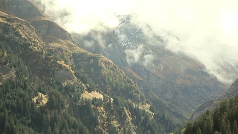 Alps. snow on peaks, trees on steep slopes. Clouds on the mountains. Switzerland Stock Footage 81425819