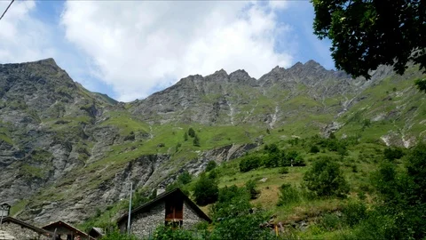 Alps Time Lapse view of a chalet with peaks and clouds running Stock Footage 94248034
