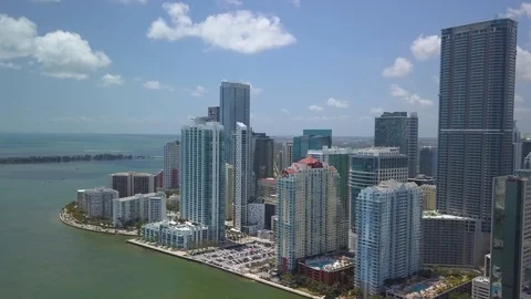 Alt puffy clouds flying left towards tip of downtown Miami skyline Stock Footage 88488588