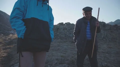 Altai 2017. Dialogue in mountains: elderly highlander communicates with tourists Stock Footage 74895391