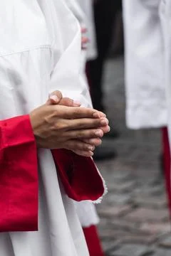 Altar servers in prayer during a religious celebration. Stock Photos
