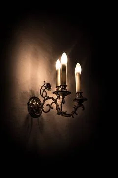 Alte elektrische Lampe an einer gekalkten Wand mit dunklem Hintergrund Alt... Stock Photos