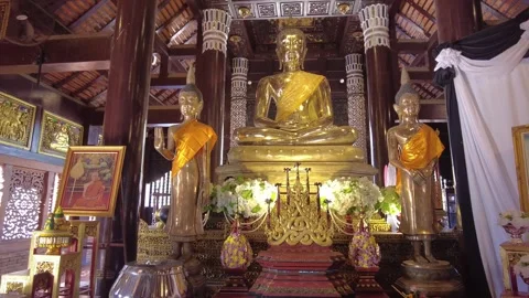 Alter decorated with gold Buddha statues inside Wat Lok Moli temple Chiang Mai Stock Footage 341636768