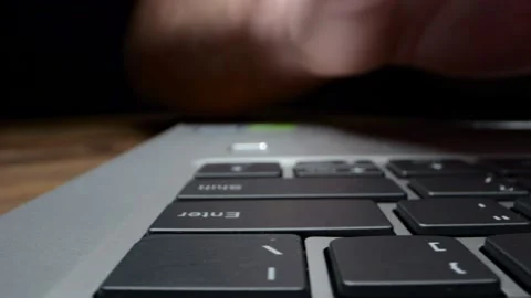 Alternate macro close-up of fingers busy working on the keyboard of a lapto.. Stock Footage 231990237