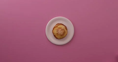 Alternating between sugar and pancakes on a white plate 2 Stock Footage 132147564