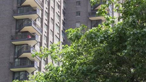 Alternating direction balconies jaggedly point out of the side of a high ris Stock Footage 242365892