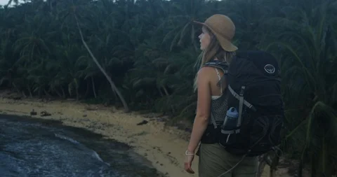 Alternative backpacker thinking about life with tropical beach in background Stock Footage 86109699