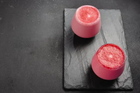 An alternative to caffeine. Beet latte on a dark background Stock Photos