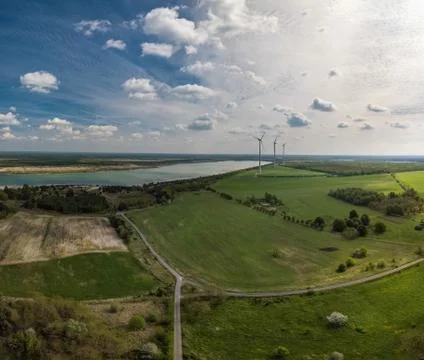 Alternative energy - wind generator wheels in backgroud of an aerial nature with Stock Photos