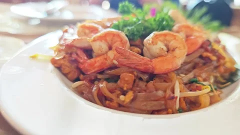 Alternative low angle view of Thai fried noodles or Pad Thai with shrimps. 스톡 동영상 347514322