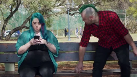 An alternative man sits beside plus size woman and they start to chat Stock Footage 139425185