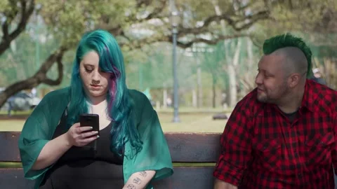 An alternative man sits beside plus size woman and they start to chat Stock-Footage 139425231