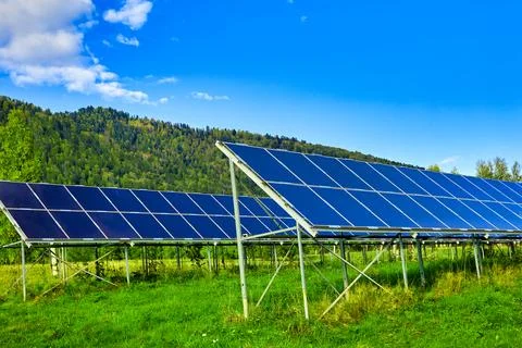 Alternative source of electricity in the form of solar panels on a hill Stock Photos