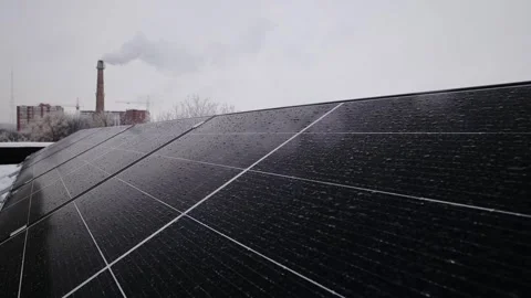 An alternative source of energy - a solar panel on the foreground and a Stock Footage 258679541