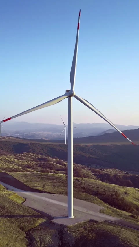 Alternative source of energy, wind turbines rotating, hilly terrain, skyline, Stock Footage 283344911