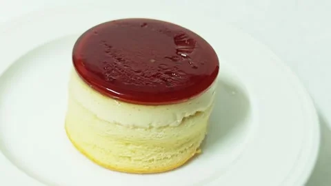 Alternative view of a caramel custard pudding cake on a white plate. Stock Footage 345338680