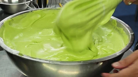 Alternative view of folding white meringue into green pandan cake batter. Stock-Footage 347068166