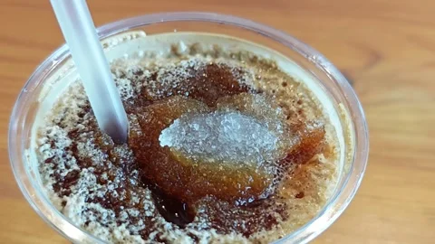 Alternative view of iced black coffee with crushed ice on a wooden table. Stock-Footage 348158190