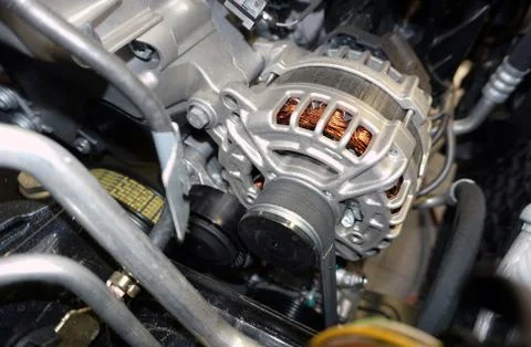 Alternator (generator) installed in the engine compartment of a modern car. Stock-Fotos