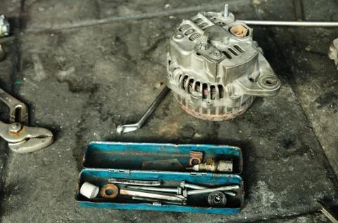 Alternators put apart for fixing with tools box. Stock Photos