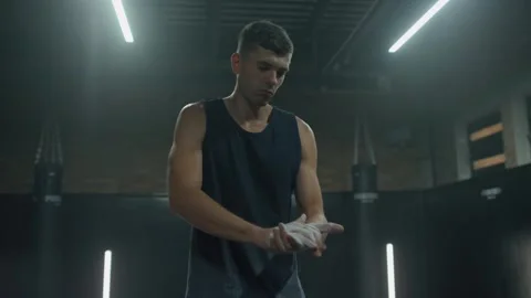 Althletic man lifting barrel exercise in dark gym. Male silhouette athlete Stock Footage 204847954