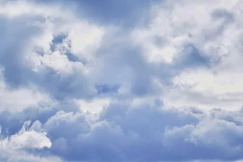 At altitude inside a white cloud, cold daylight on the clouds in the sky. Stock Photos